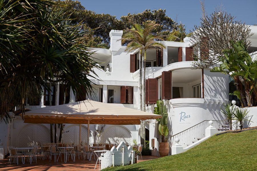 The Raes property exterior with the restaurant umbrellas in the foreground.